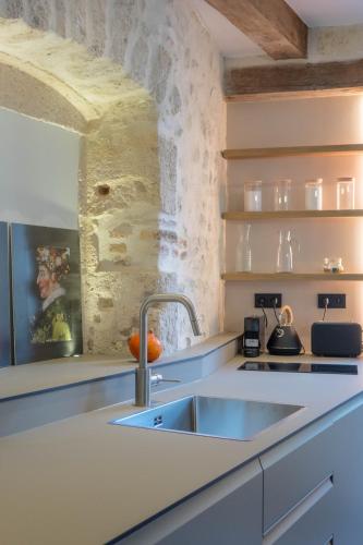 a kitchen with a sink and a counter top at Le Clos du XVIe - Exceptional accommodation in Orléans