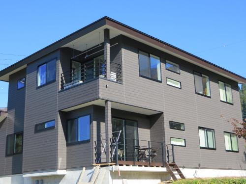 a large building with a balcony on top of it at Toi,toi,toi in Nozawa Onsen
