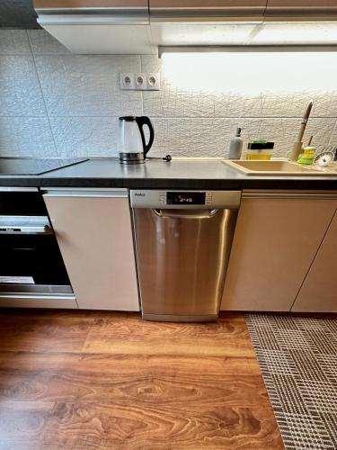 a kitchen with a sink and a counter top at Unique main square apartment - AC - Balcony - Coffee Machine - Washer - Kitchen- Parking available Free public or Paid Private for 20 euro per stay Please read our emails in Poprad