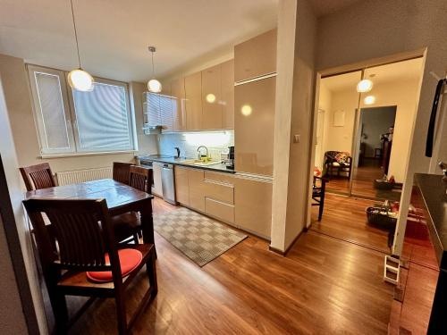 a kitchen with a table and a dining room at Unique main square apartment - AC - Balcony - Coffee Machine - Washer - Kitchen- Parking available Free public or Paid Private for 20 euro per stay Please read our emails in Poprad