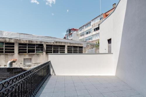 an external view of a building with a white wall at Get a Golden and Flower Flat in Porto