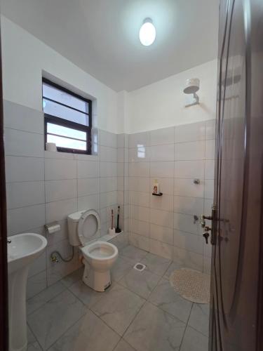a bathroom with a toilet and a sink at Misty Cabins in Ruringʼu