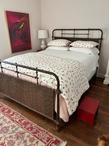 a bedroom with a bed with a metal frame at House on the Gwynns Falls in Baltimore