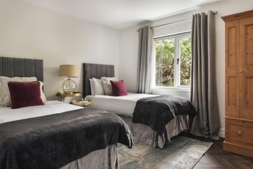 a bedroom with two beds and a window at Bellfoot Rural Retreat and Hot Tub in Grasmere