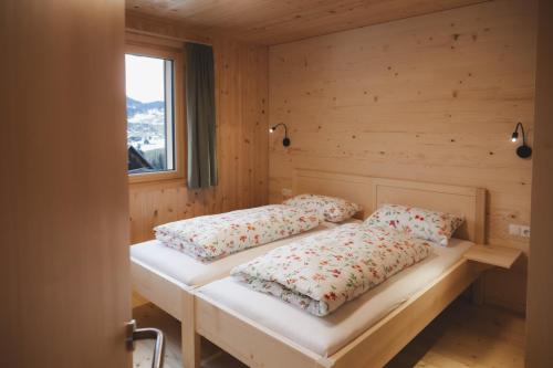 a room with two beds in a wooden cabin at Ferienwohnung Flatz in Egg