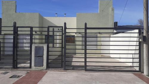 a gate in front of a building at Complejo Tres Arroyos in Tres Arroyos