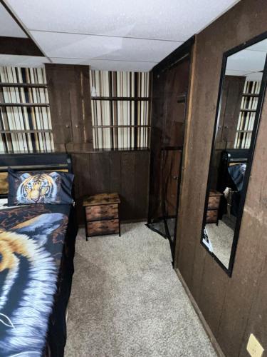 a bedroom with a bed and a large mirror at MidwestBNB Room1, quite cabin in the wood vibes in Minneapolis