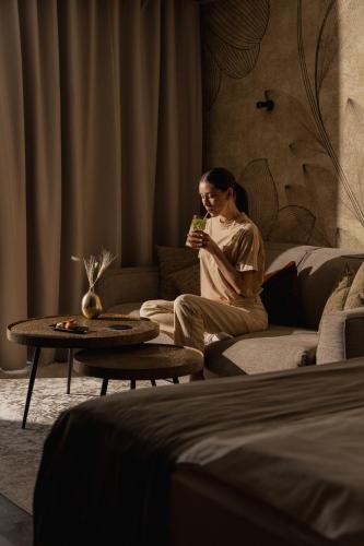 a woman sitting on a couch in a living room at Chalet Mirabell in Avelengo