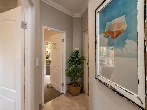 a hallway with a large painting on the wall at Waves & Whales in Brenton-on-Sea