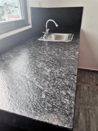a kitchen counter with a sink and a window at Gran Plaza, Cancún in Cancún