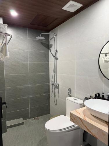 a bathroom with a shower and a toilet and a sink at Sapa Landscape Homestay in Sapa