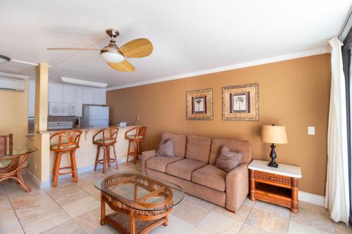 a living room with a couch and a table at Kona Reef Resort by Latour Group in Kailua-Kona