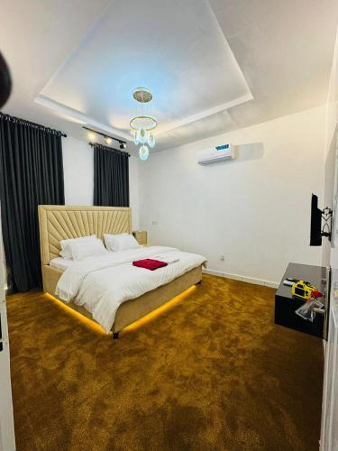 a bedroom with a large bed in a room at Premium Luxury Apartments in Abuja