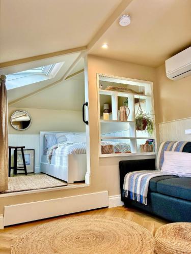 a bedroom with a mirror and a bed in it at The Snug, Minehead in Minehead