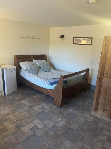 a bedroom with a bed in a room at Crowtrees Barns in Waterhouses