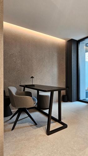 a table and a chair in a room at Kalvokoresi 16 I Premium Apartments in Chios