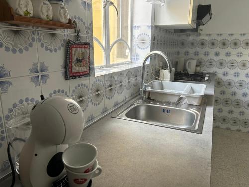 a kitchen with a sink and a hello kitty mixer at Apartment in Żebbuġ Malta in Ħal Muxi