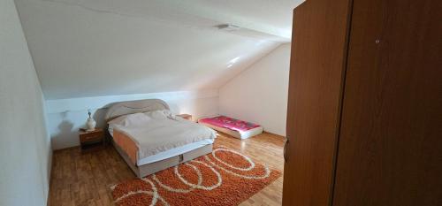 a small bedroom with a bed in a attic at Villa Aida in Cazin