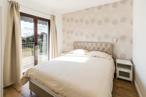 a bedroom with a large bed and a window at Apartments Dorijan with Pool in Matulji