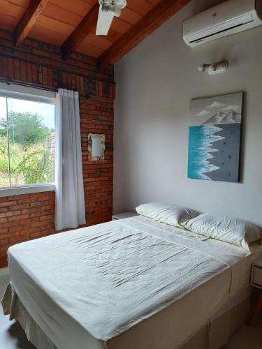 a large bed in a room with a window at Casita de Natalia in San Bernardino