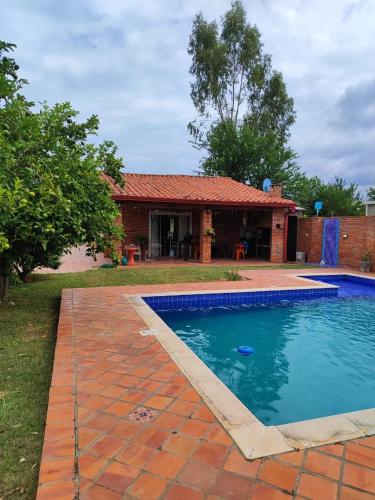 a swimming pool in front of a house at Casita de Natalia in San Bernardino
