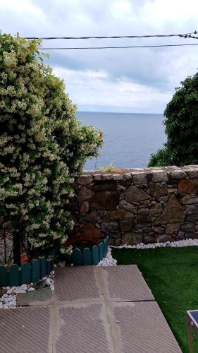 a stone wall with a view of the ocean at la terrazza relax in Corniglia