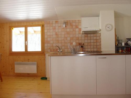 a kitchen with a sink and a counter top at Grand chalet en Gruyère in Sorens