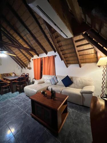 a living room with a white couch and a table at Apartamento en planta alta 2 dormitorios in Piriápolis