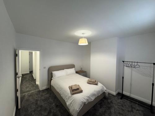 a bedroom with a bed with two towels on it at 18 Morawel in Burry Port