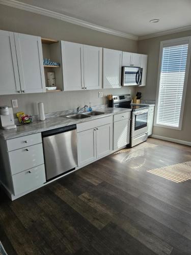 a kitchen with white cabinets and stainless steel appliances at Apartment in Cleveland in Cleveland
