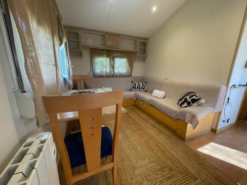a small room with a bed and a table at La casita in Pinilla del Valle