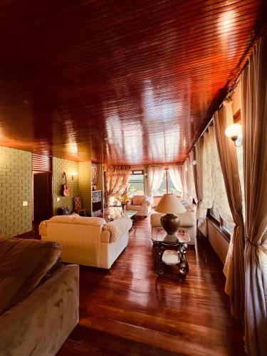 a living room with couches and a couch and a table at Mansão Bardo in Petrópolis
