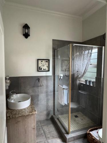a bathroom with a shower and a sink at BLessing at Lynnwood in Pretoria