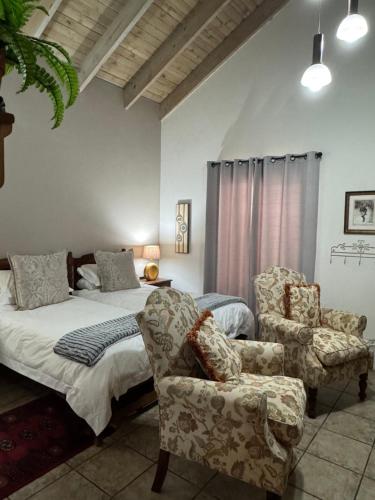 a bedroom with a bed and a chair at BLessing at Lynnwood in Pretoria