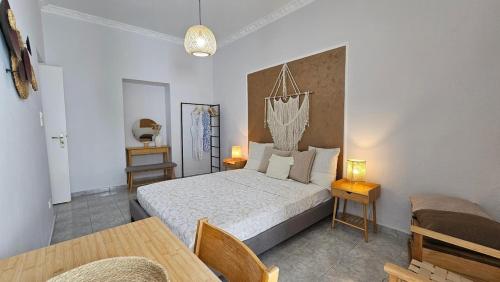 a bedroom with a bed and a table and chairs at Plaka View Nest in Plaka Milou