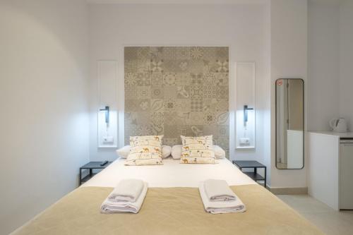 a bedroom with a large bed with two towels on it at Comfortable Room close to City Centre in Valencia