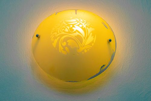 a yellow ball with a design on a wall at A4S Hotel in Ouagadougou