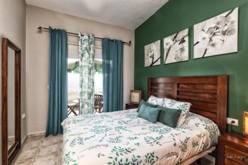 a bedroom with a bed and a green wall at casa moni 2 in El Paso