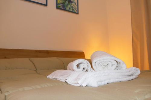 two rolled towels sitting on top of a bed at Vista Mare 22 Due Camere triple o doppie in Bari