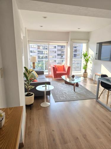 a living room with a couch and two tables at Residence Polanco, Security24h, Balcony, Pool, Gym, CarPark in Mexico City