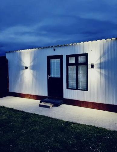 a white building with a black door and windows at The Mayfair Lodge & Family Suite in Hartlepool