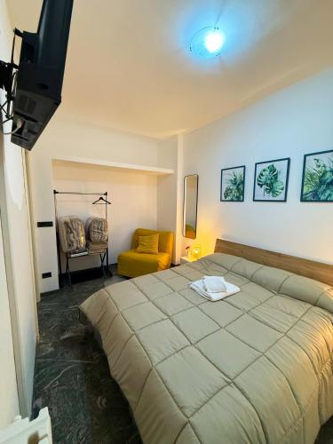 a bedroom with a large bed and a yellow chair at Vista Mare 22 Due Camere triple o doppie in Bari