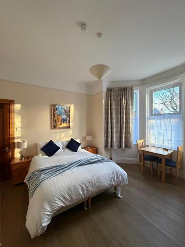 a bedroom with a bed and a table and a window at ABC House in Dublin