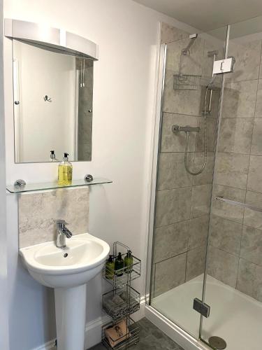 a bathroom with a sink and a shower at Stag Cottage in Ilkeston