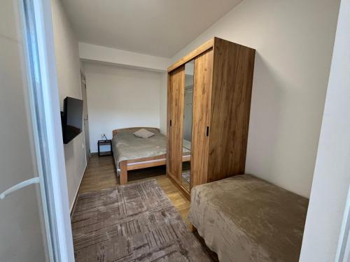 a small room with a bed and a closet at Apartman Mimoza - Meljine in Meljine