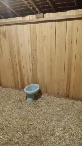 a blue toilet sitting in front of a wooden wall at Sawinsrom Homestay in Fam