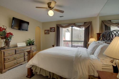 a bedroom with a bed and a ceiling fan at Rivers Edge Condo 902 in Helen