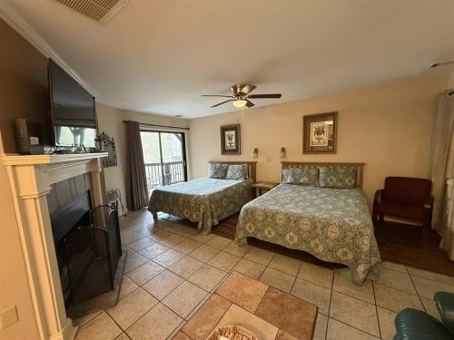 a bedroom with two beds and a fireplace at Rivers Edge 803 in Helen