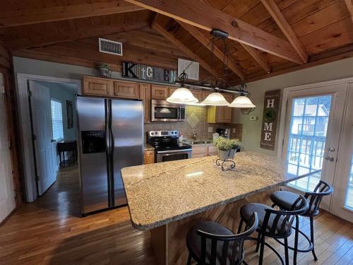 a kitchen with a granite counter top and a refrigerator at Bavarian Brook Condo 12 in Helen