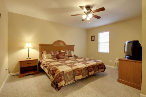 a bedroom with a bed and a ceiling fan at Bavarian Brook Condo 10 in Helen